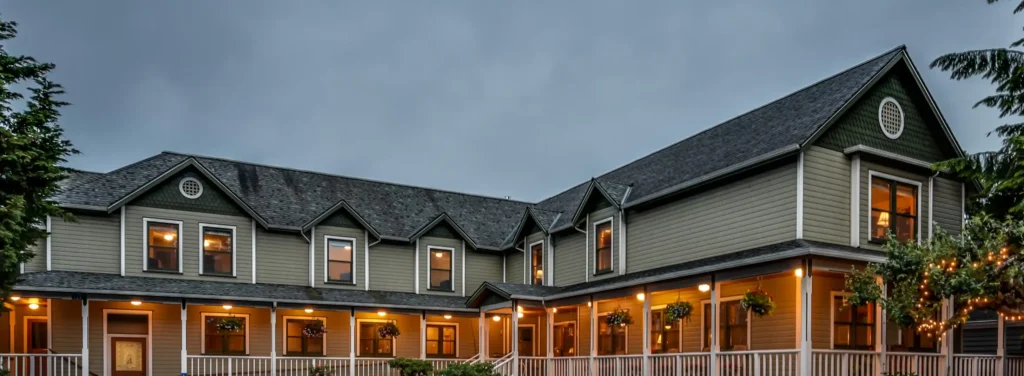 a large house with a porch and a white railing