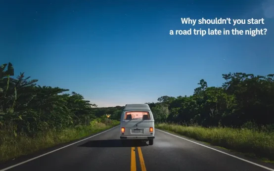 A nighttime road trip scene with a white van driving on a two-lane road surrounded by lush greenery. The sky is clear, and there are a few stars visible. The text "Why Shouldn't You Start a Road Trip Late in the Night?" is placed at the top right corner of the image.