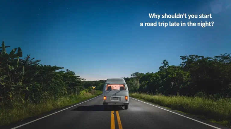 A nighttime road trip scene with a white van driving on a two-lane road surrounded by lush greenery. The sky is clear, and there are a few stars visible. The text "Why Shouldn't You Start a Road Trip Late in the Night?" is placed at the top right corner of the image.